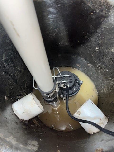 Aging pump with corroded discharge lines in a stainless basin